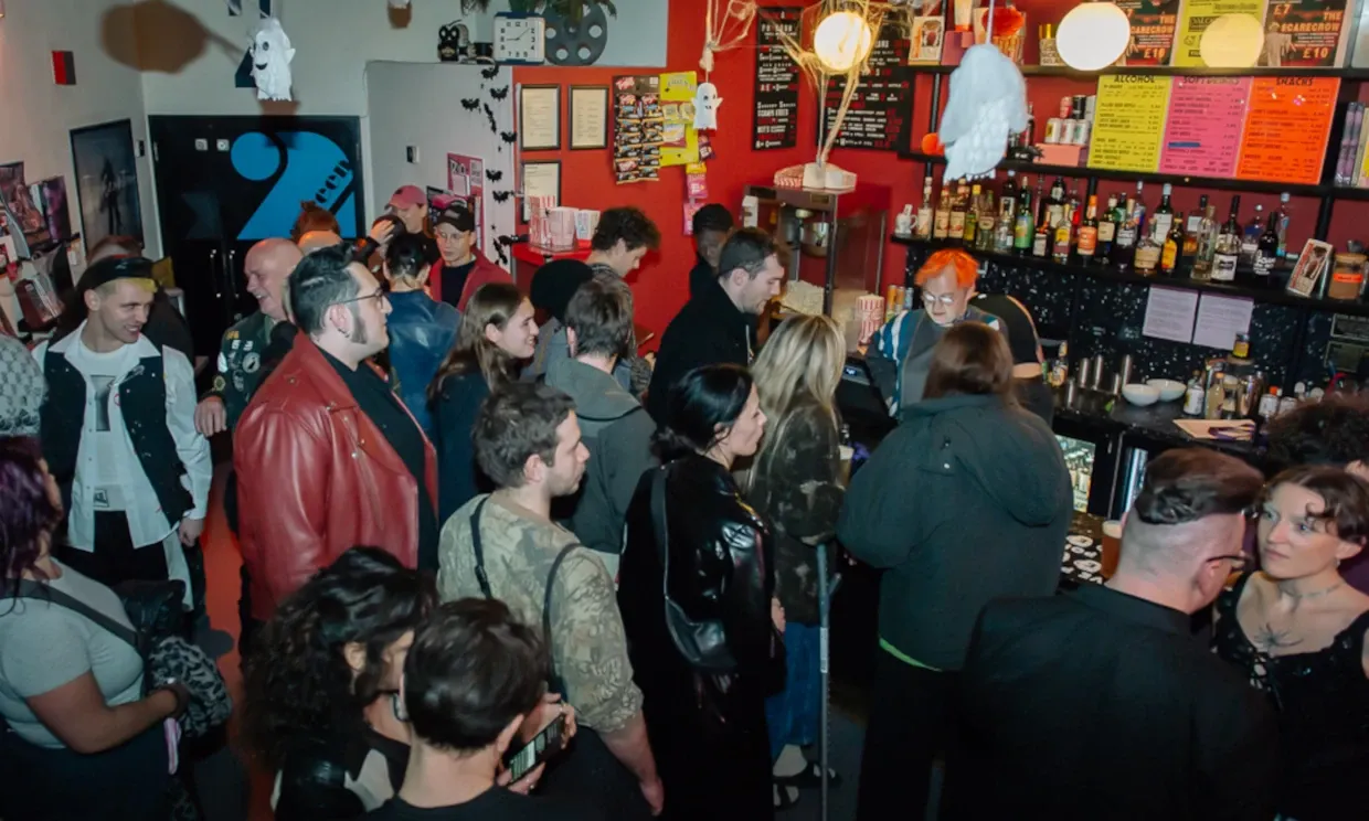 People gathered in the auditorium of the Rio cinema buying tickets and popcorn.