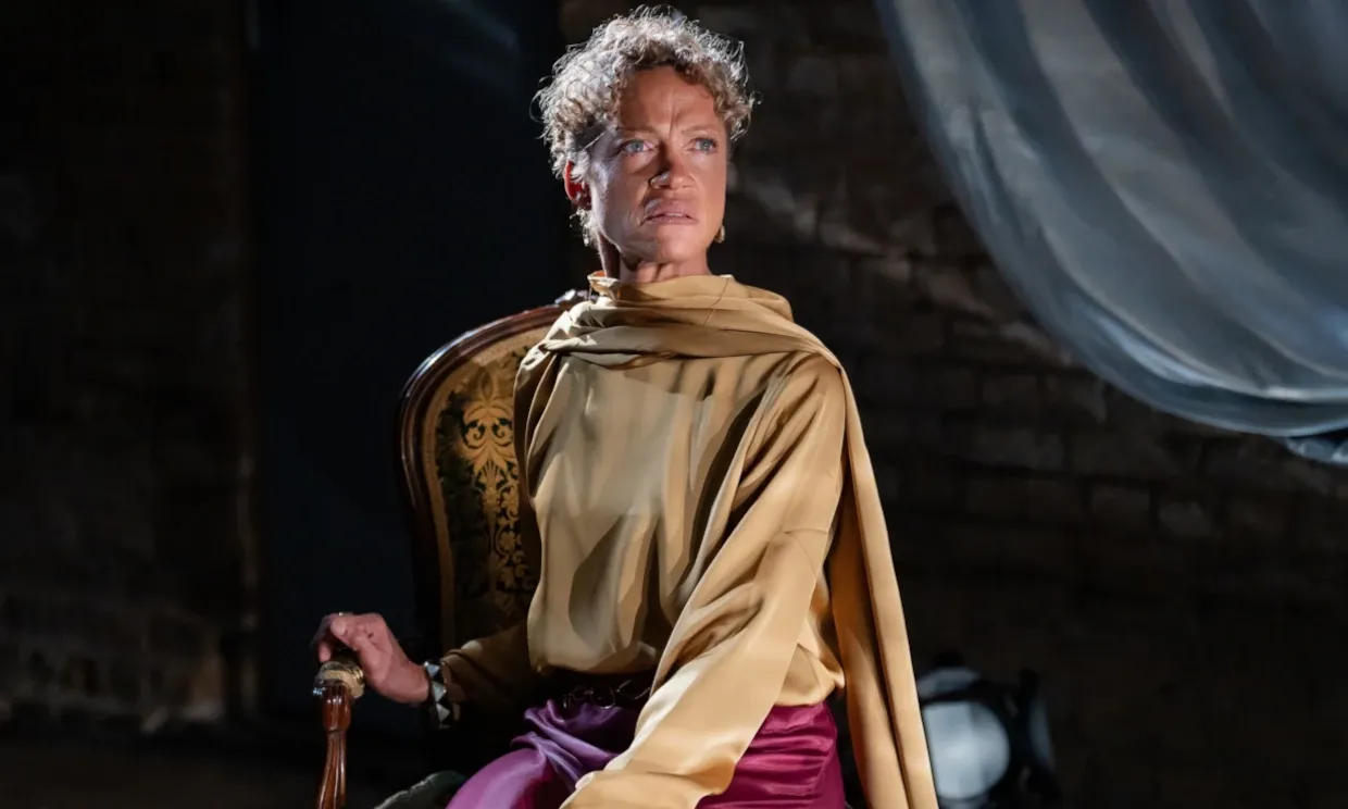 Indra sat in a chair looking angered.