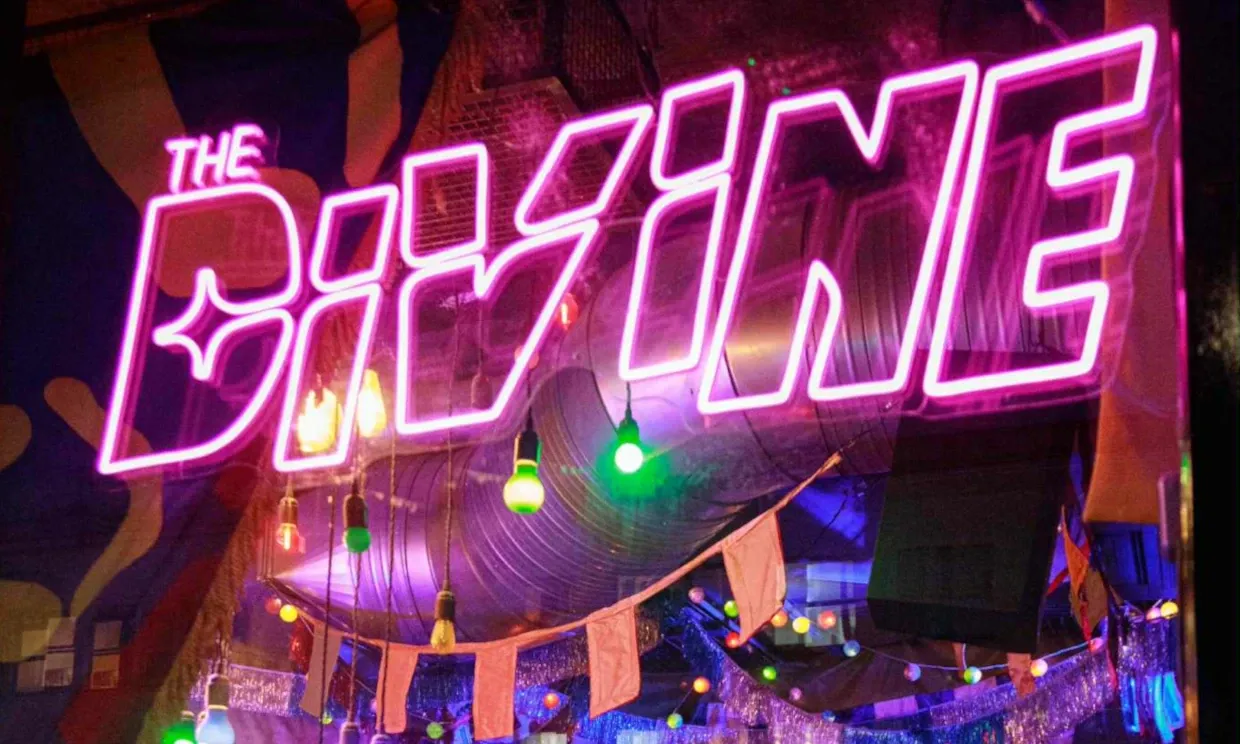 Large neon sign saying 'The Divine'.