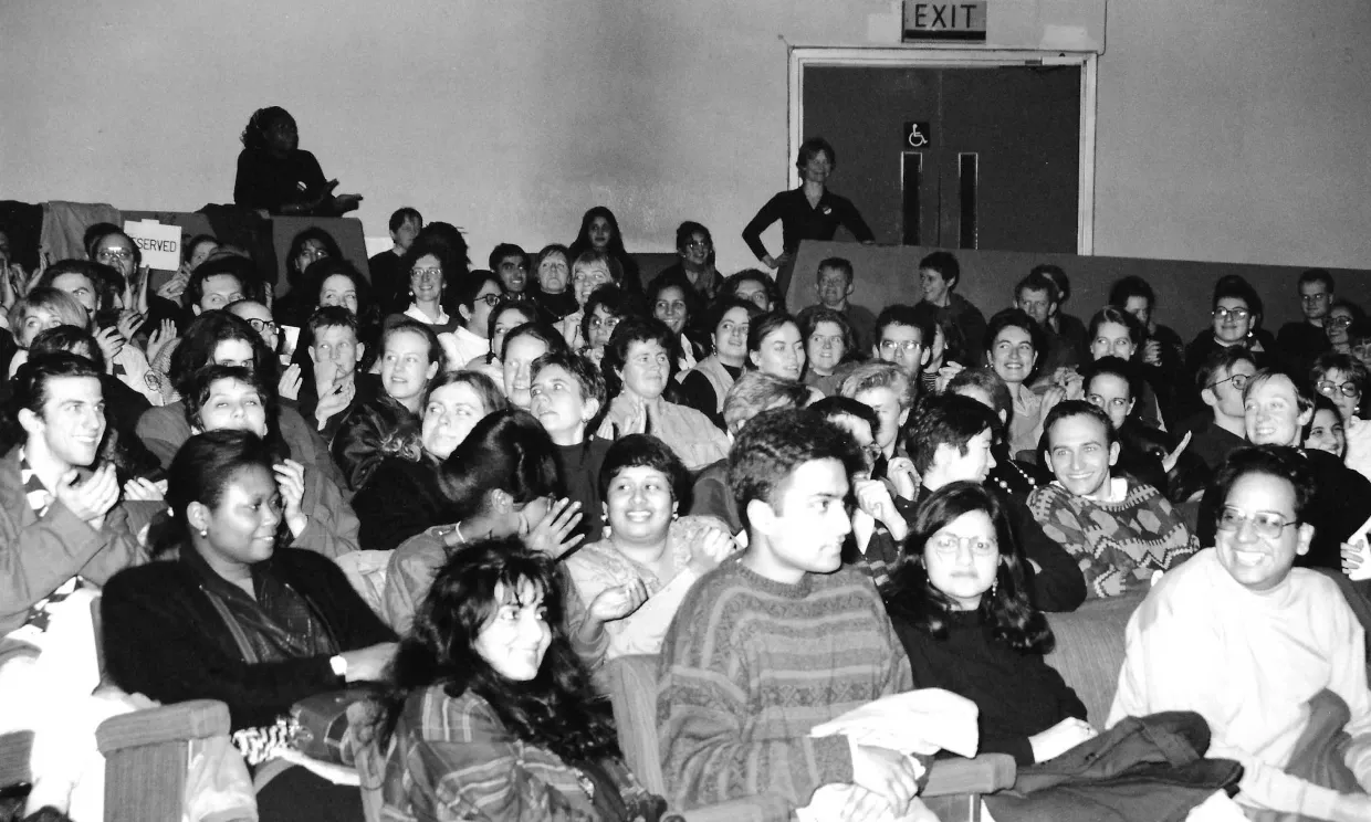 An old, black and white photo of many people seated in the Rio.