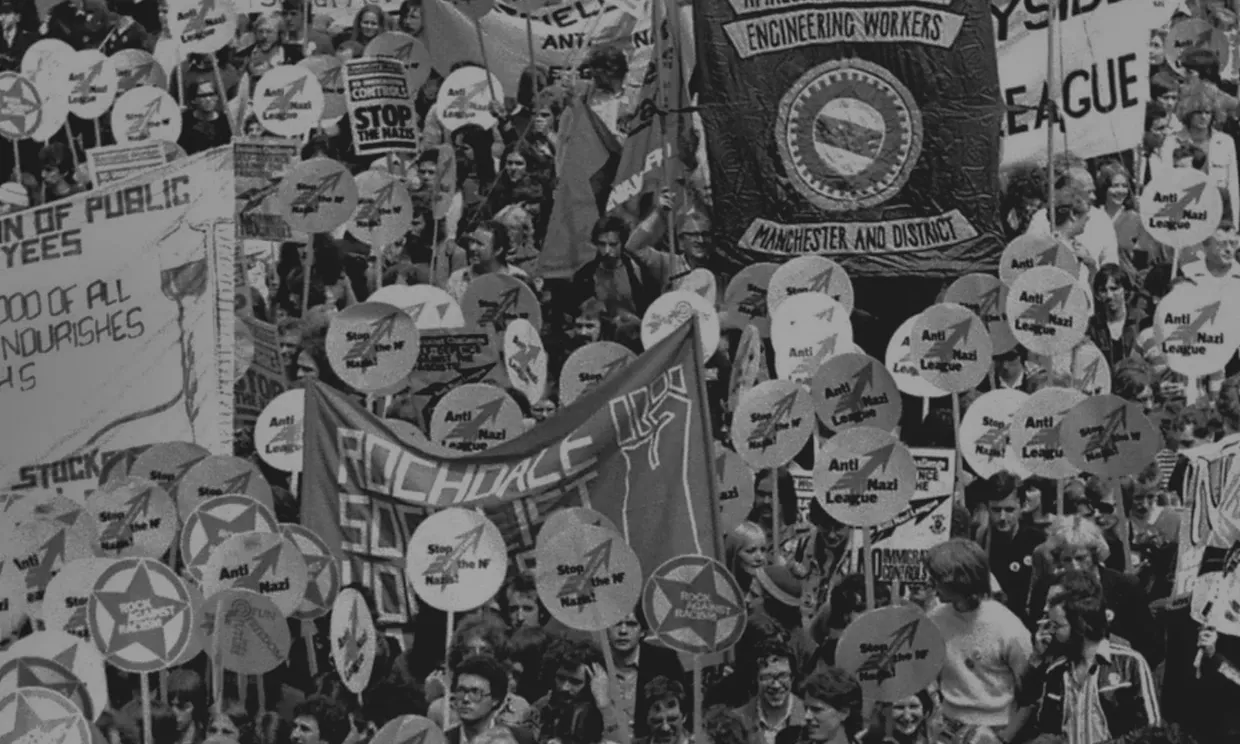 People gather in the streets with Stop the Nazis signs