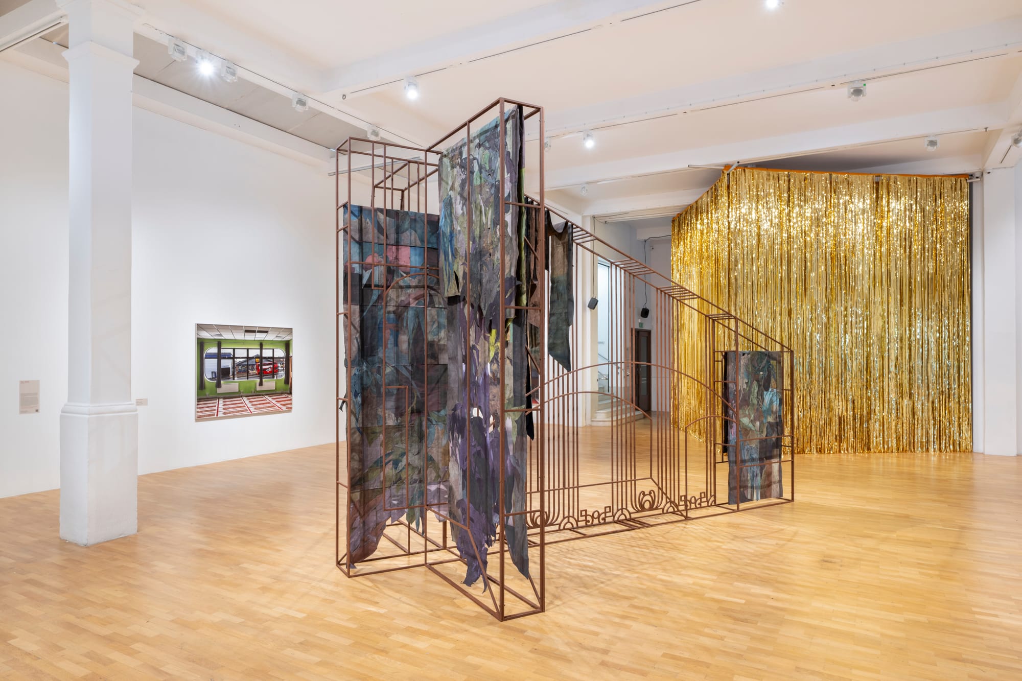An angular metal sculpture is in the centre of a gallery room.