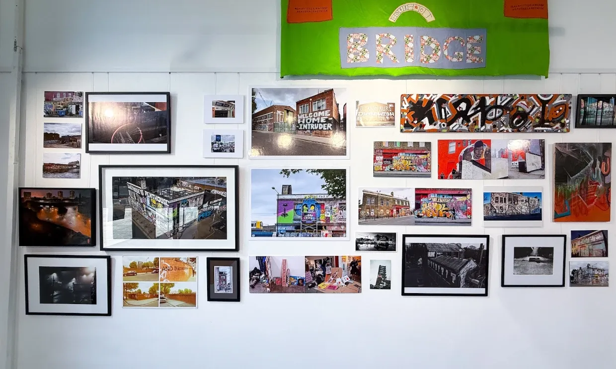 A collection of photos of Hackney Wick framed on a wall