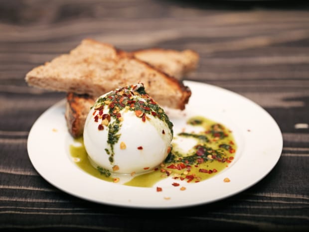 Burrata with basil oil, chili flakes and sourdough bread. Photograph courtesy of Bones