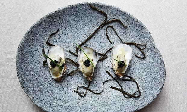 Champagne poached oyster with truffle and chive scrambled eggs 