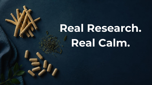 Ashwagandha root, green tea leaves, and magnesium capsules arranged on a navy background, representing natural anxiety support options