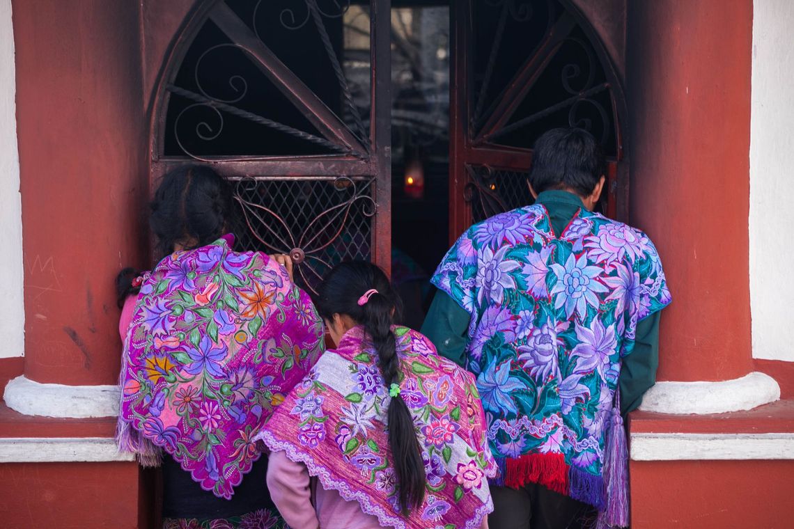 Indigenous people praying in a chapel adjacent to Iglesia de San Cristobalito.