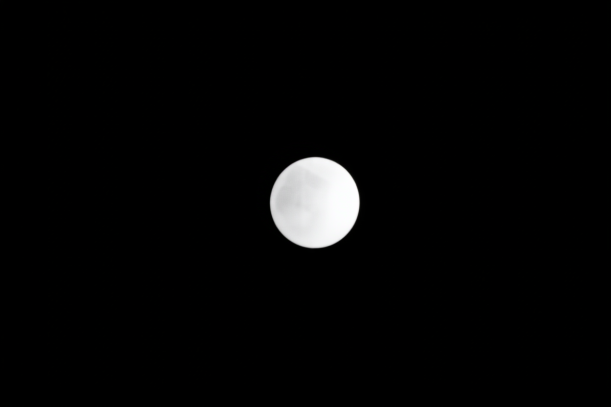 a digital camera lens reflecting a grid of photo thumbnails on a dark background
