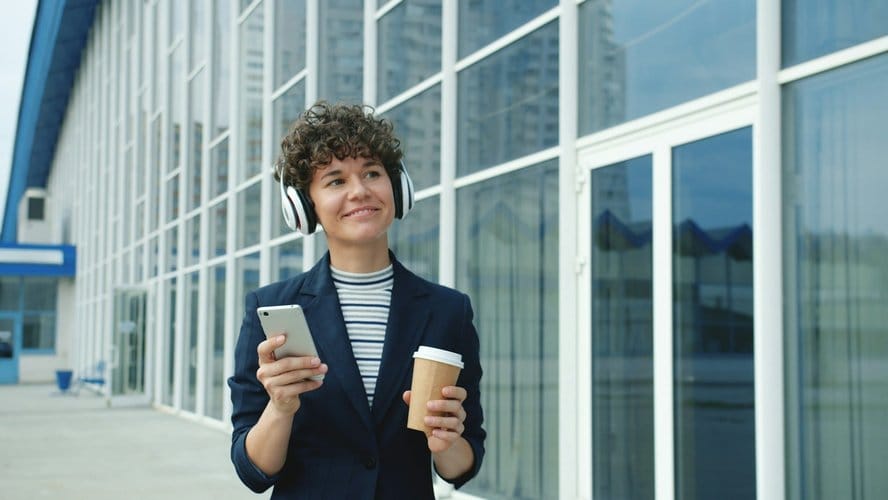 Woman holding a phone, representing audiobook app access