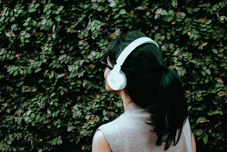 Person listening to an audiobook through headphones