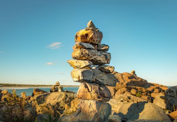 photo of stacked rocks on beach
