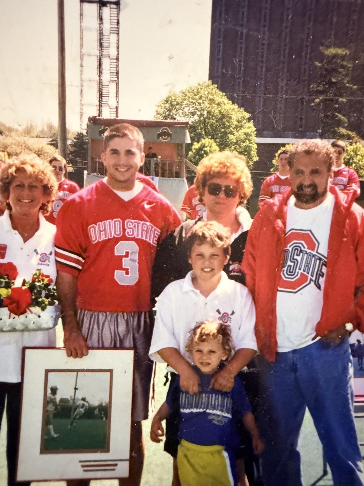 The Curry family at Ohio Stadium — Carol Koury with flowers, Fred III in OSU #3, Kandi, Mike, Nick, and Flying Fred Curry.