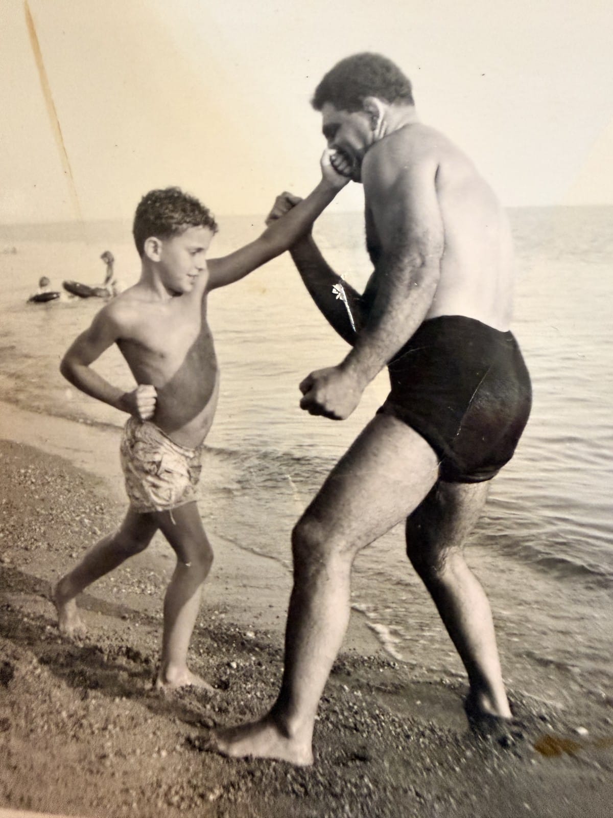 Wild Bull Curry wrestling young Fred on the beach. Father and son playing at what will become his trade.