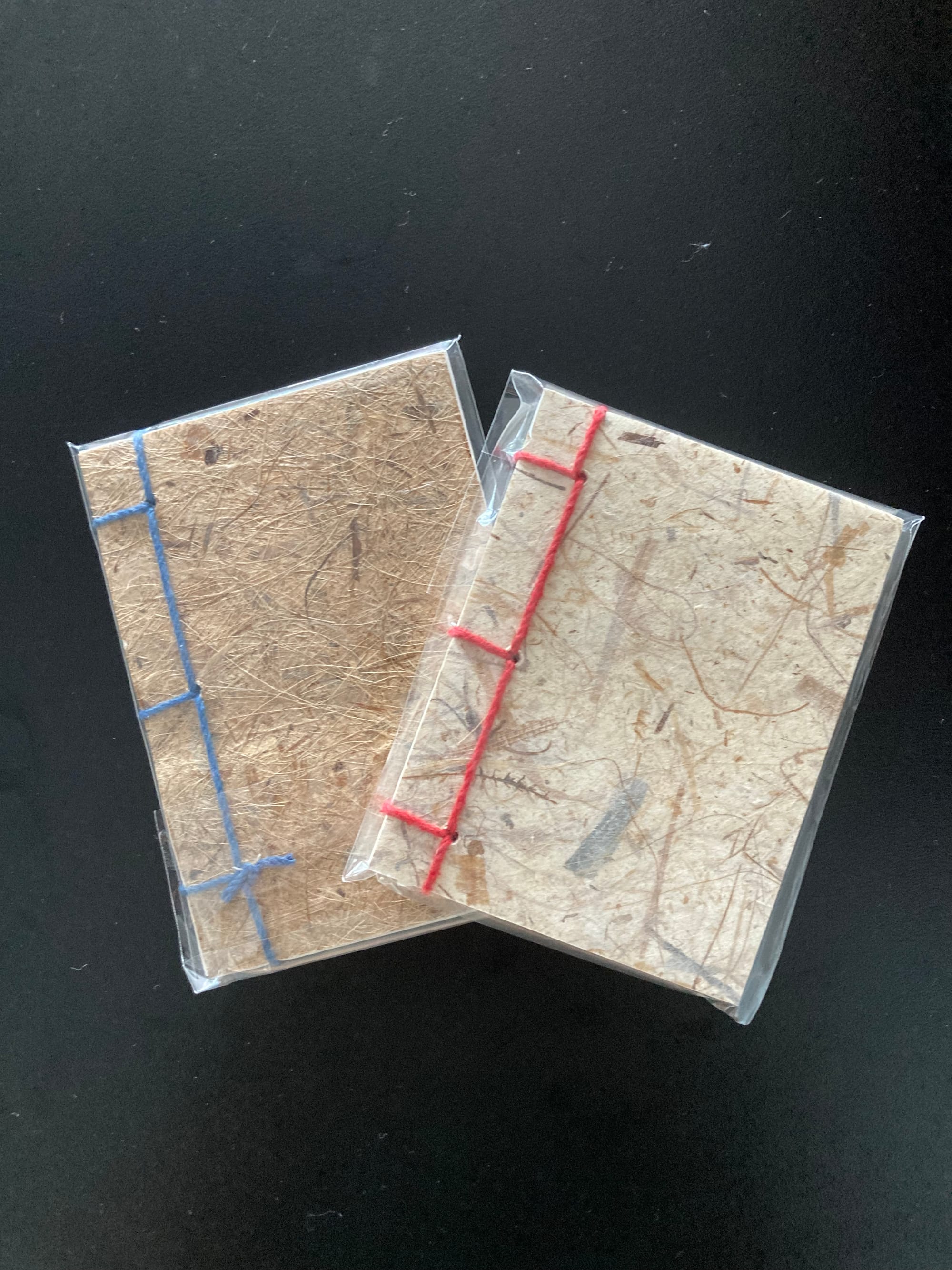 Two traditionally bound small notebooks made from handmade Korean paper.