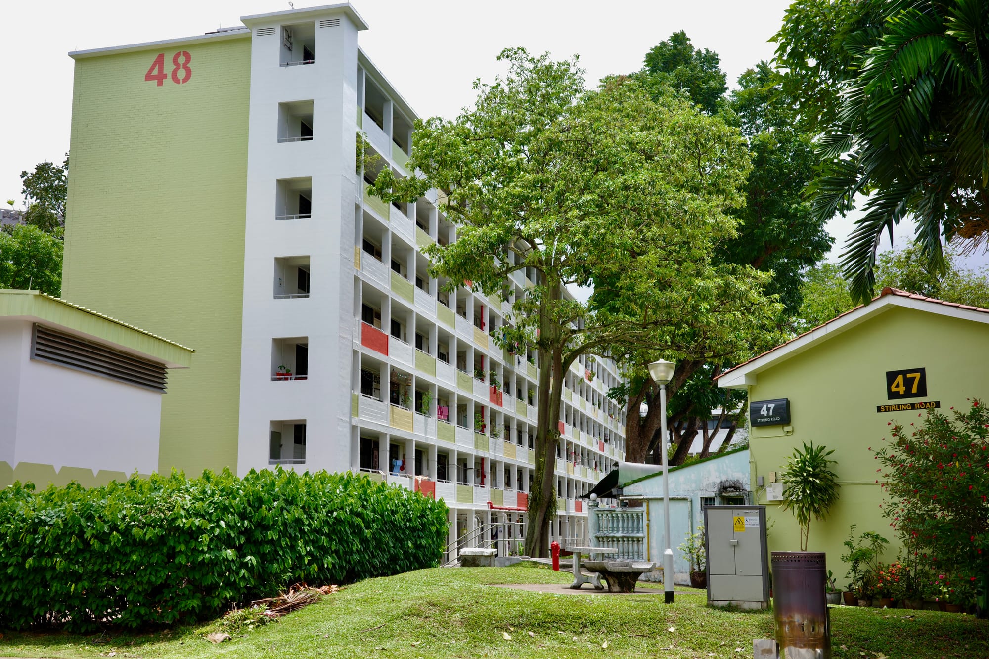 A 7-storey block of flats with the number ‘48’ on its side. To its right is a block of terraced housing.