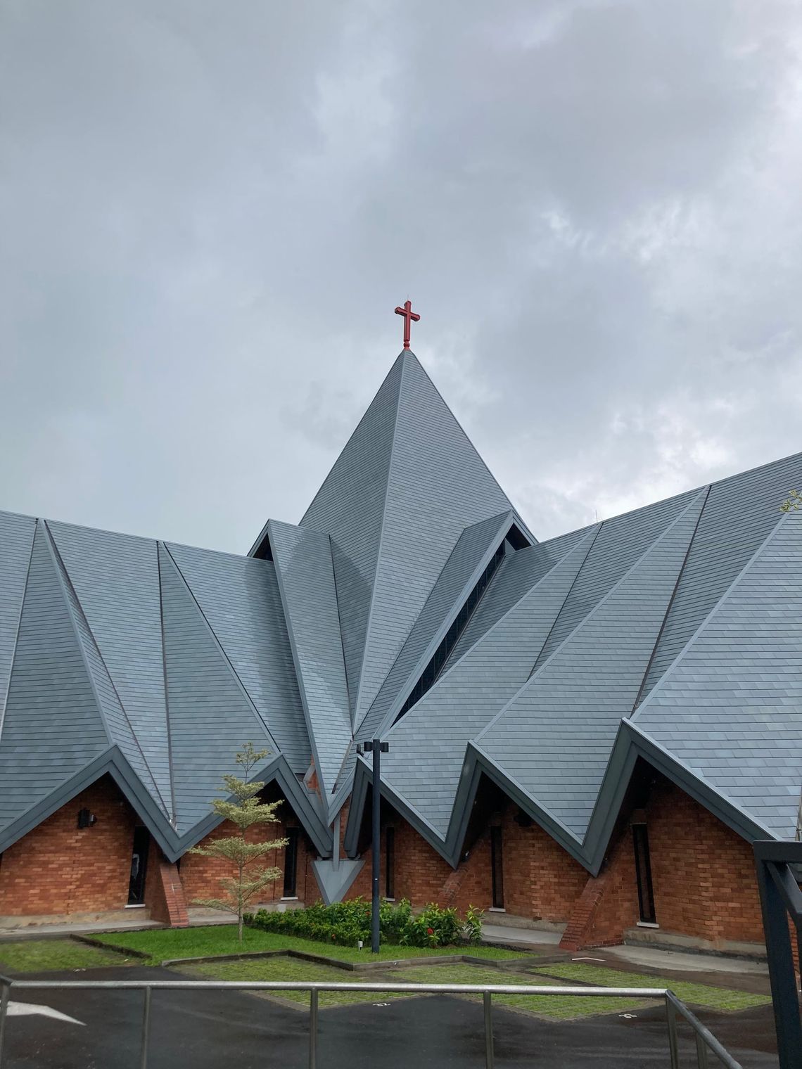 A church with a striking, angular grey roof shaped to look like folds of a tent.