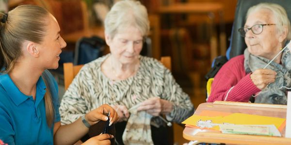 a care home caregiver with 2 older women with dementia and dysphagia 