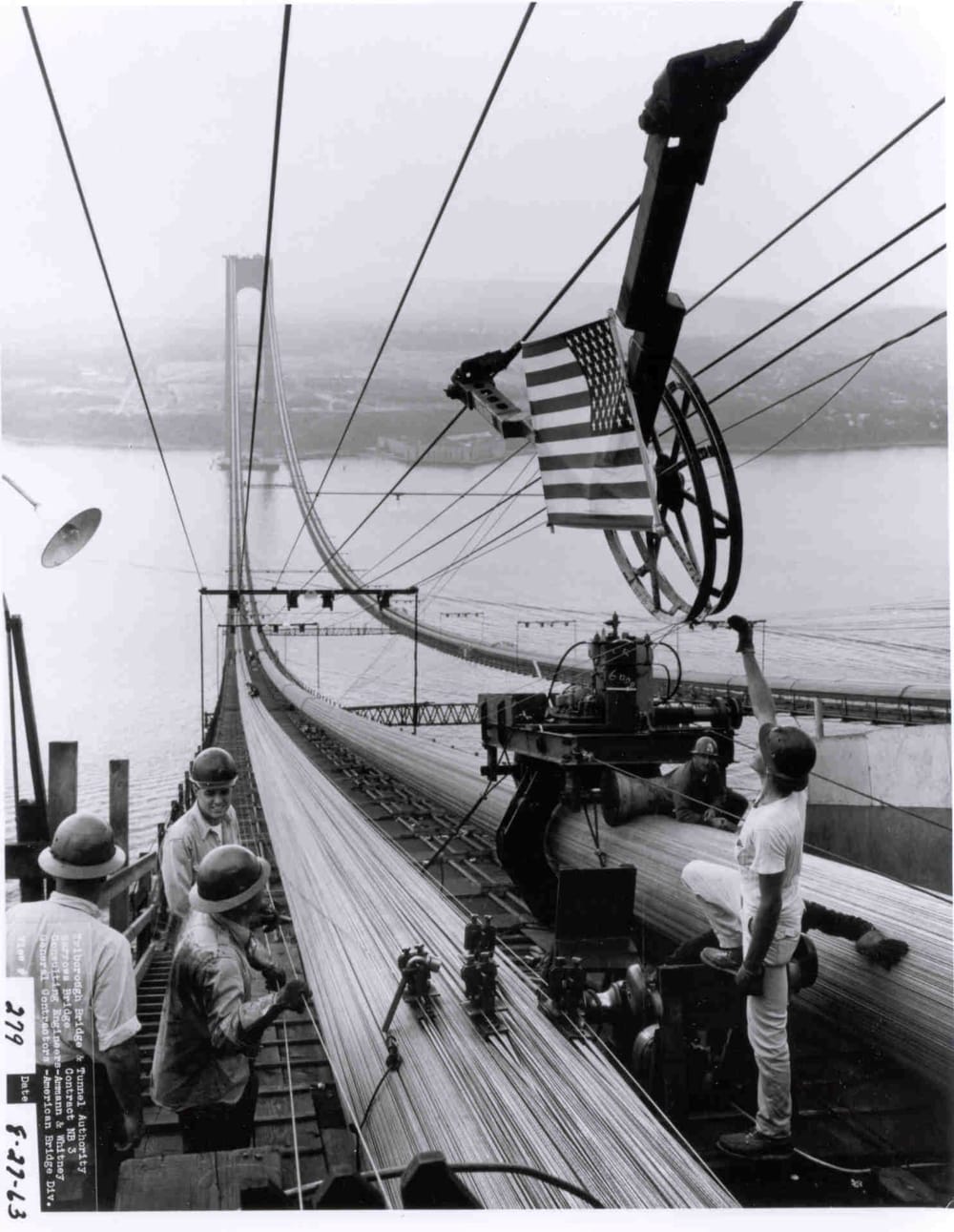 Brooklyn - cable squeezing apparatus erected on "C" cable. Flag draped on "D" cable wheel for "Trial". August 27, 1963 