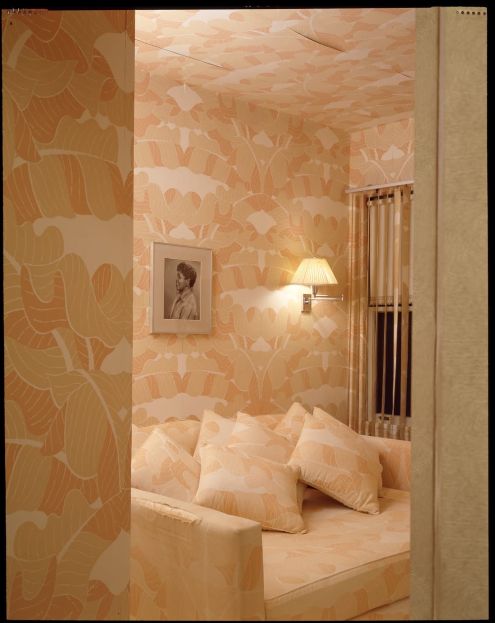 A couch and colorful wallpaper in the Louis Armstrong House