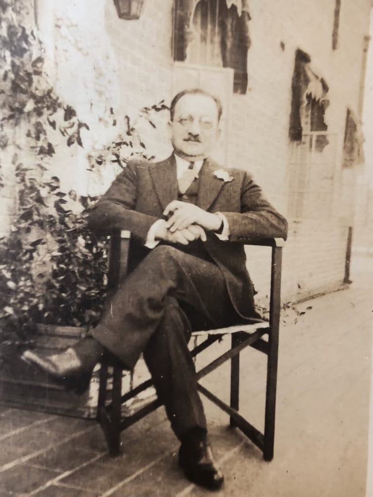 Architect Emery Roth sits in a chair