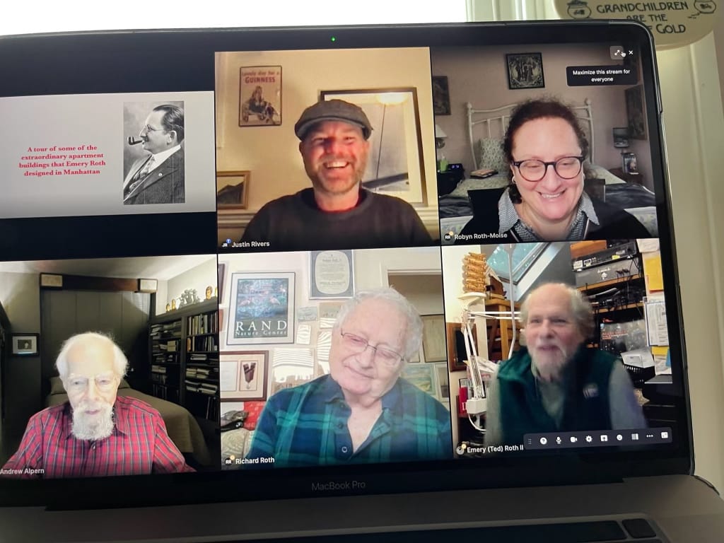 Photo of a laptop screen with a zoom meeting with four men and one woman