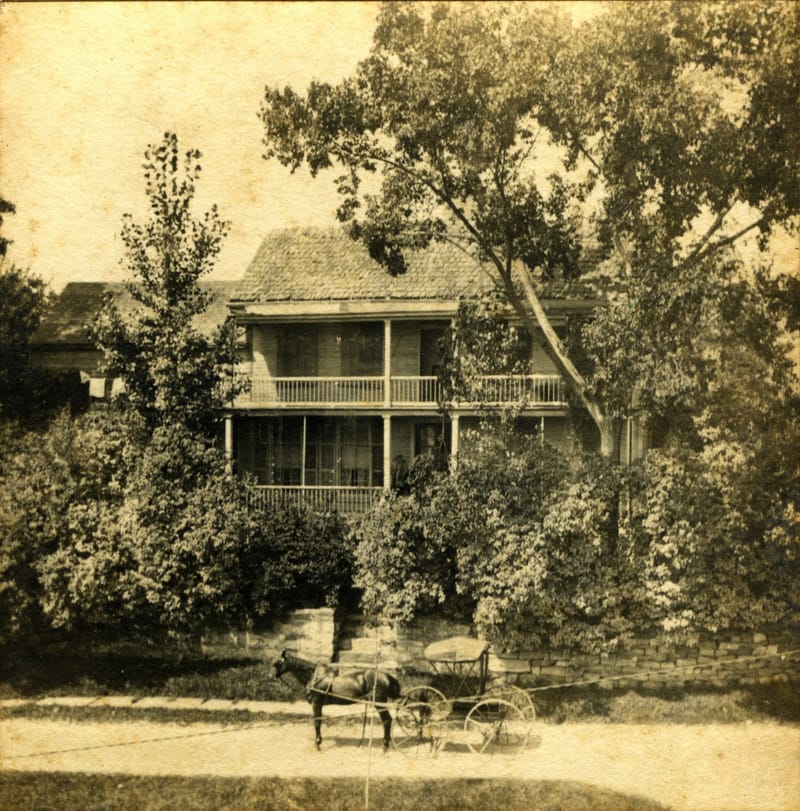 A horse and carriage sit outside the Bush-Holley House
