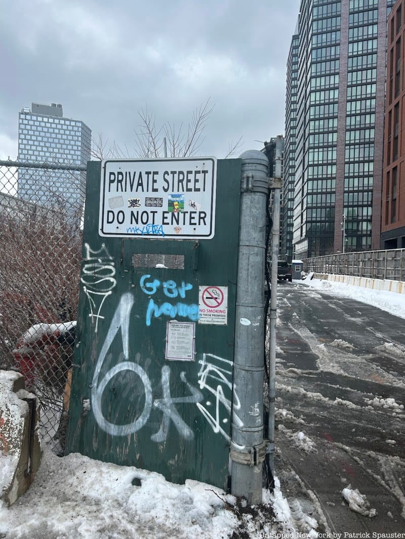 A sign that reads "Private Street Do No Enter" posted on a fence