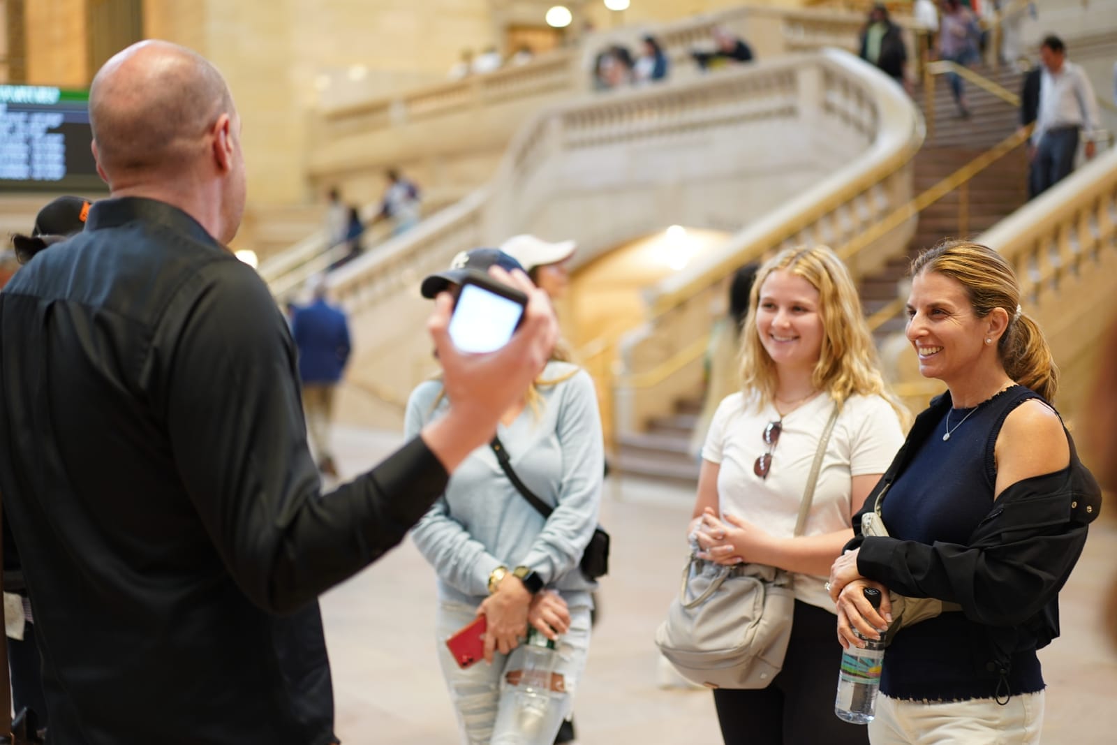 Two women and a tour guide inside Grand Central Terminal