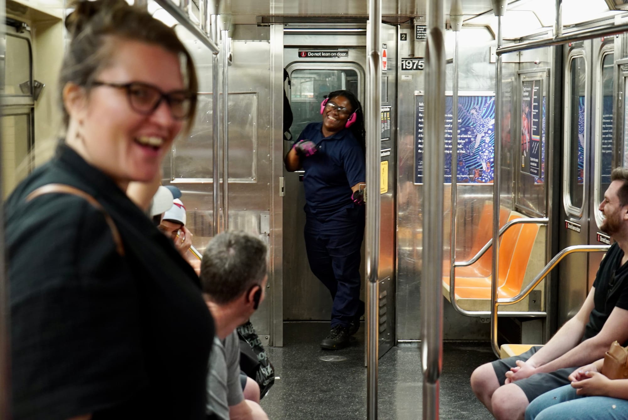 A subway conductor stands inside a subway car