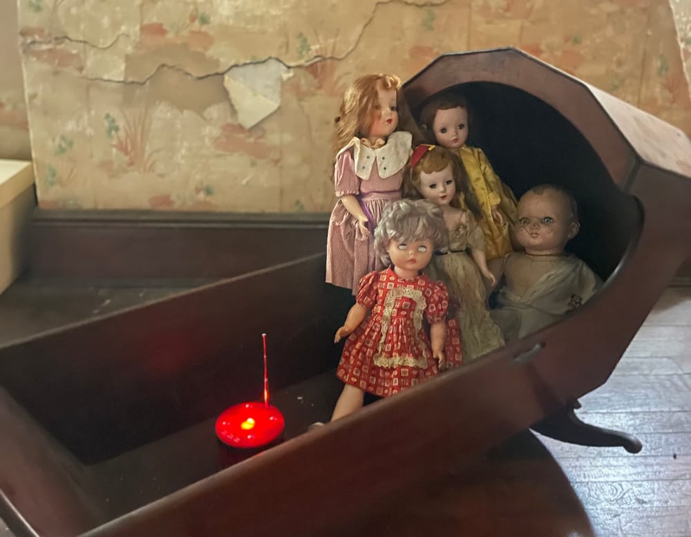 A cradle full of dolls with a red glowing meter