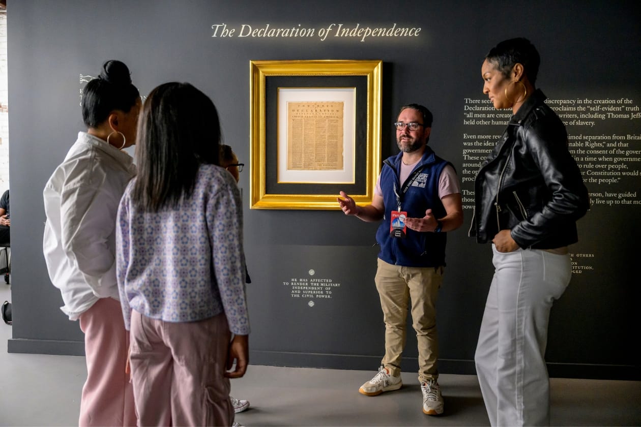 People looking at the Declaration of Independence at the Seaport Museum