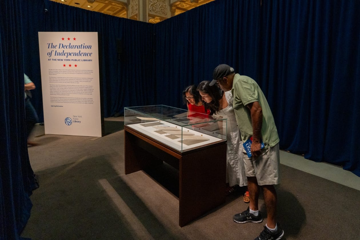 Guests view a handwritten copy of the Declaration of Independence at the NYPL
