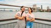 Two women standing in front of the Brooklyn Bridge