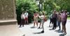 Tourgoers on a Remnants of Dutch New Amsterdam tour touch a stone wall in the subway
