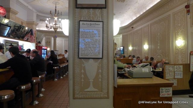 The cashier is in the center of it all - opposite the open doors leading to the hotel