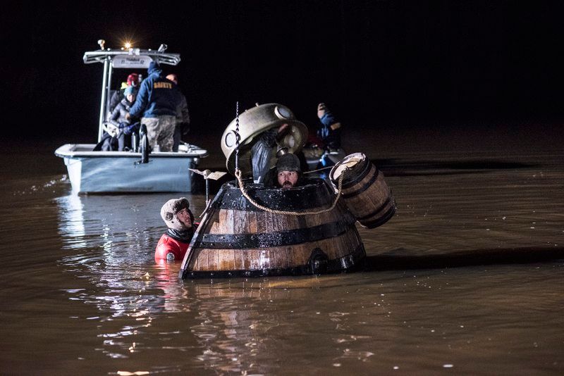 replica of the Turtle submarine nearly submerged in dark water during a nighttime scene from AMC's TURN: Washington's Spies, with safety divers and a support boat nearby.