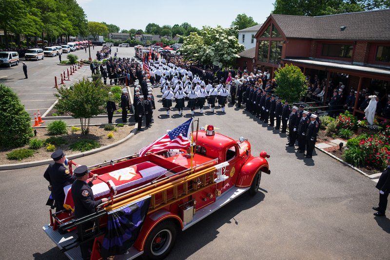 A parade of firefighters with a firetruck