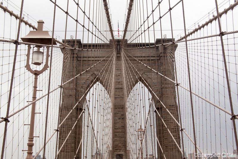Cables stretching from the top of the Brooklyn Bridge