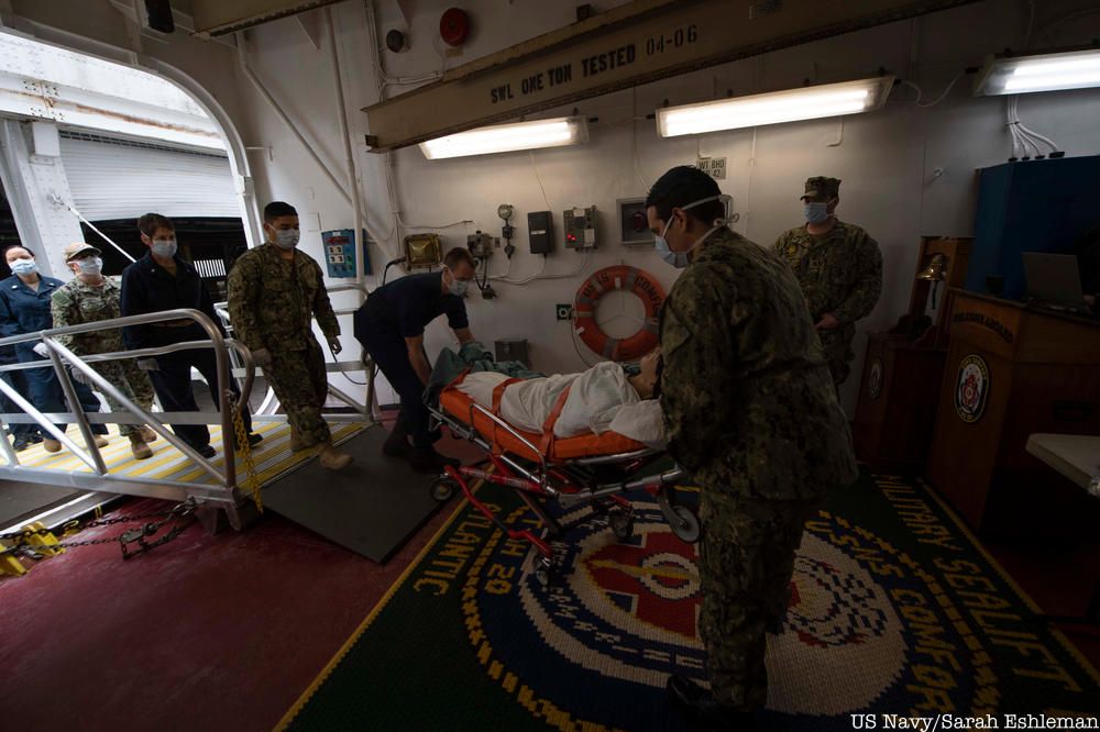 Sailors practice patient transfer from the pier onto the hospital ship USNS Comfort (T-AH 20) as they prepare to admit patients in support of the nation's COVID-19 response efforts.