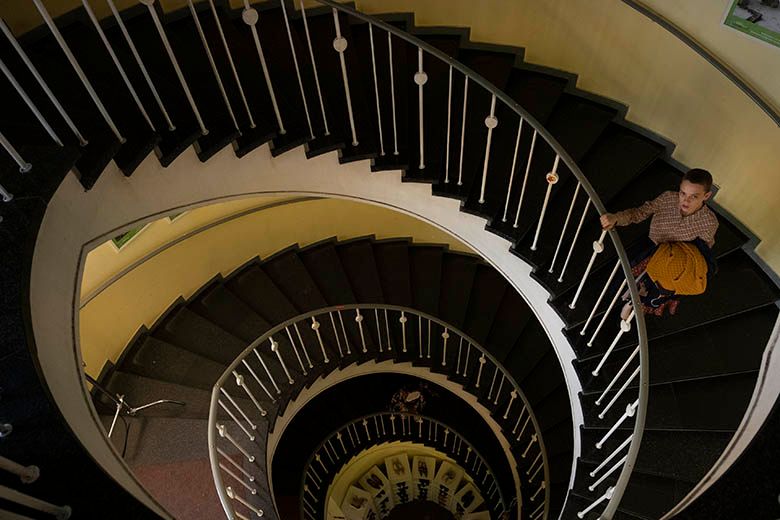 Esty Shapiro going down spiral staircase at Humana secondhand vintage store