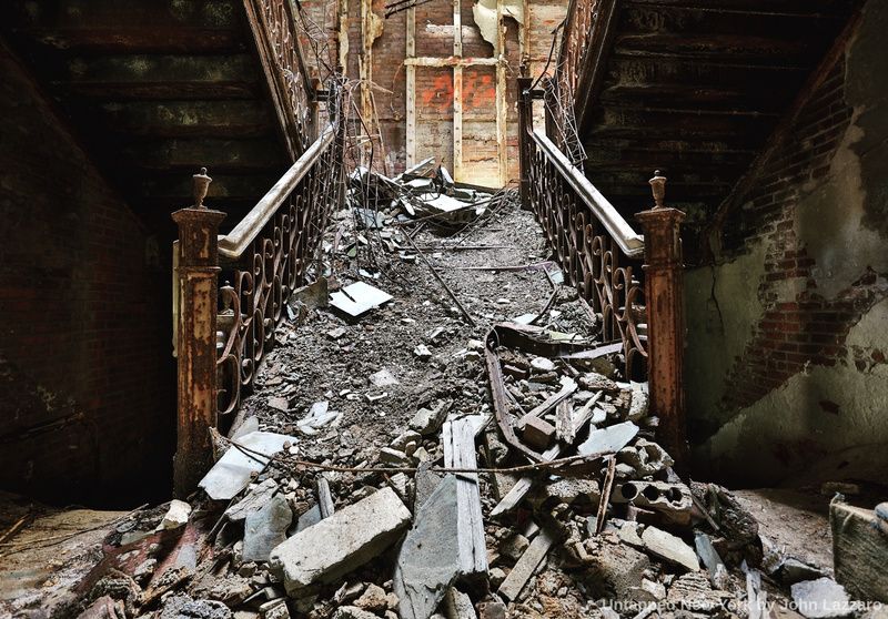A crumbling staircase inside Saratoga County Homestead Sanatorium