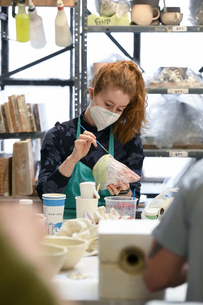 A woman paints a project at Greenwich House