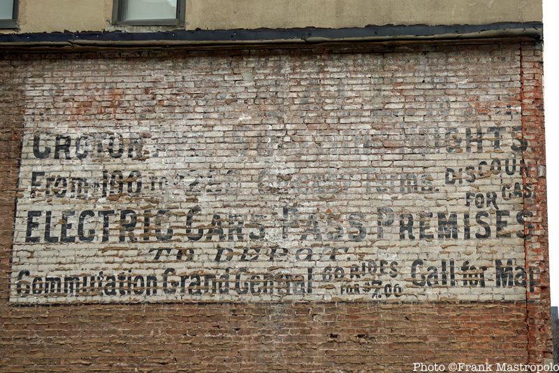 A real estate ghost sign painted onto a brick wall