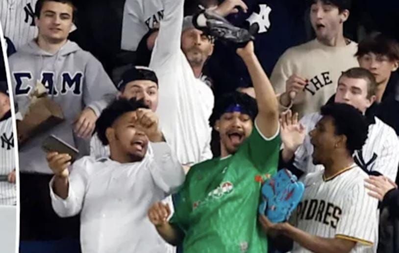 Aaron Judge watches his home run as fans in the stands react.