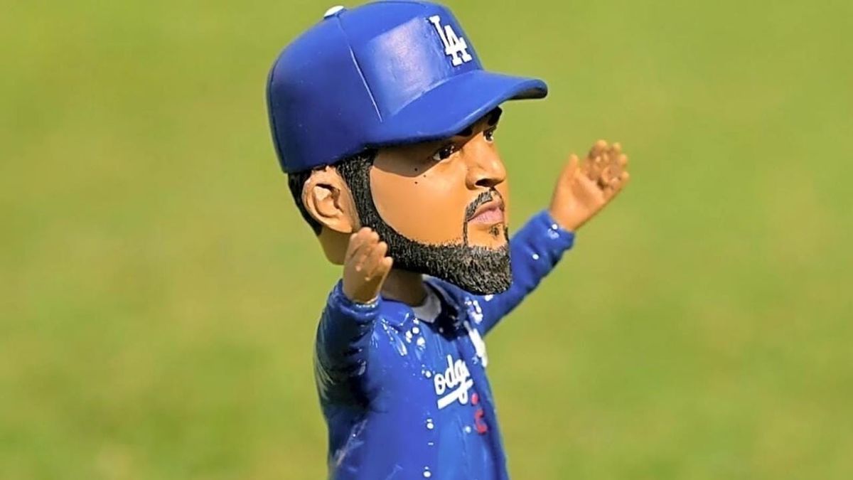 Fans line up outside a stadium holding collectible bobbleheads on giveaway night