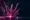Five glowing pink CS2 weapon skins fanned out like cards above a dark glass pedestal in a moody studio.