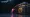 A Karambit | Fade with an orange-to-magenta blade next to a CS:GO Weapon Case, the classic case that can drop a Karambit.
