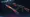 A Fade Butterfly Knife with a gold-to-purple blade next to an AK-47 | Redline rifle with red stripes, representing the move from CS:GO to CS2.