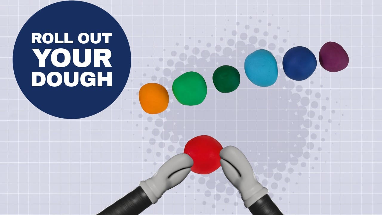 Different colored dough balls lined up to form a caterpillar's body.