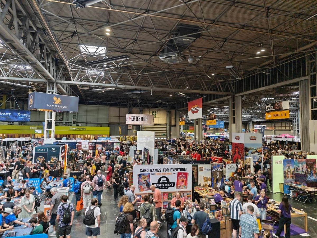 A photo from the UK Games Expo held at the NEC in Birmingham. There are hundreds of people in shot, looking at various stands
